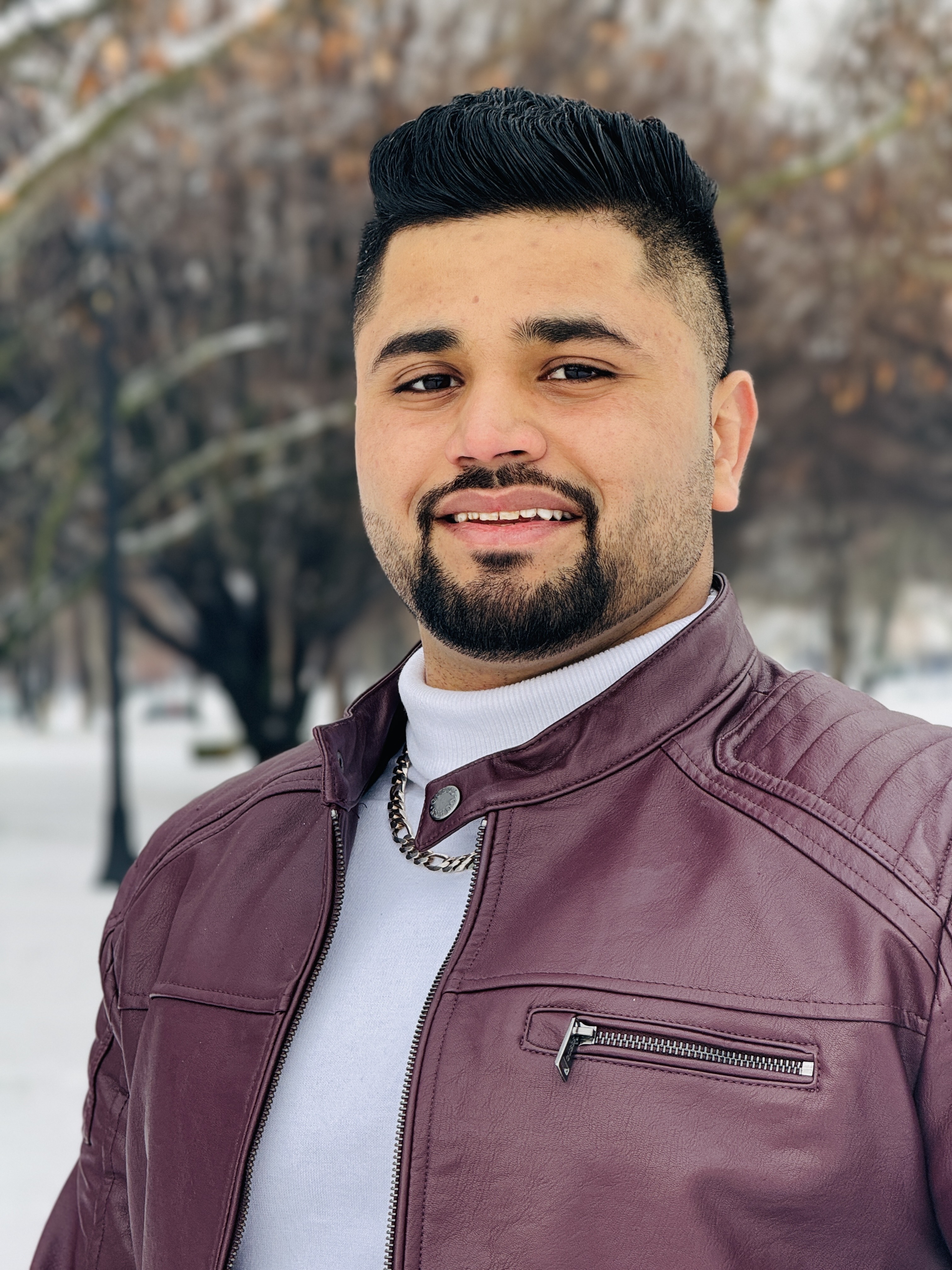 Two people smiling, exchanging car keys